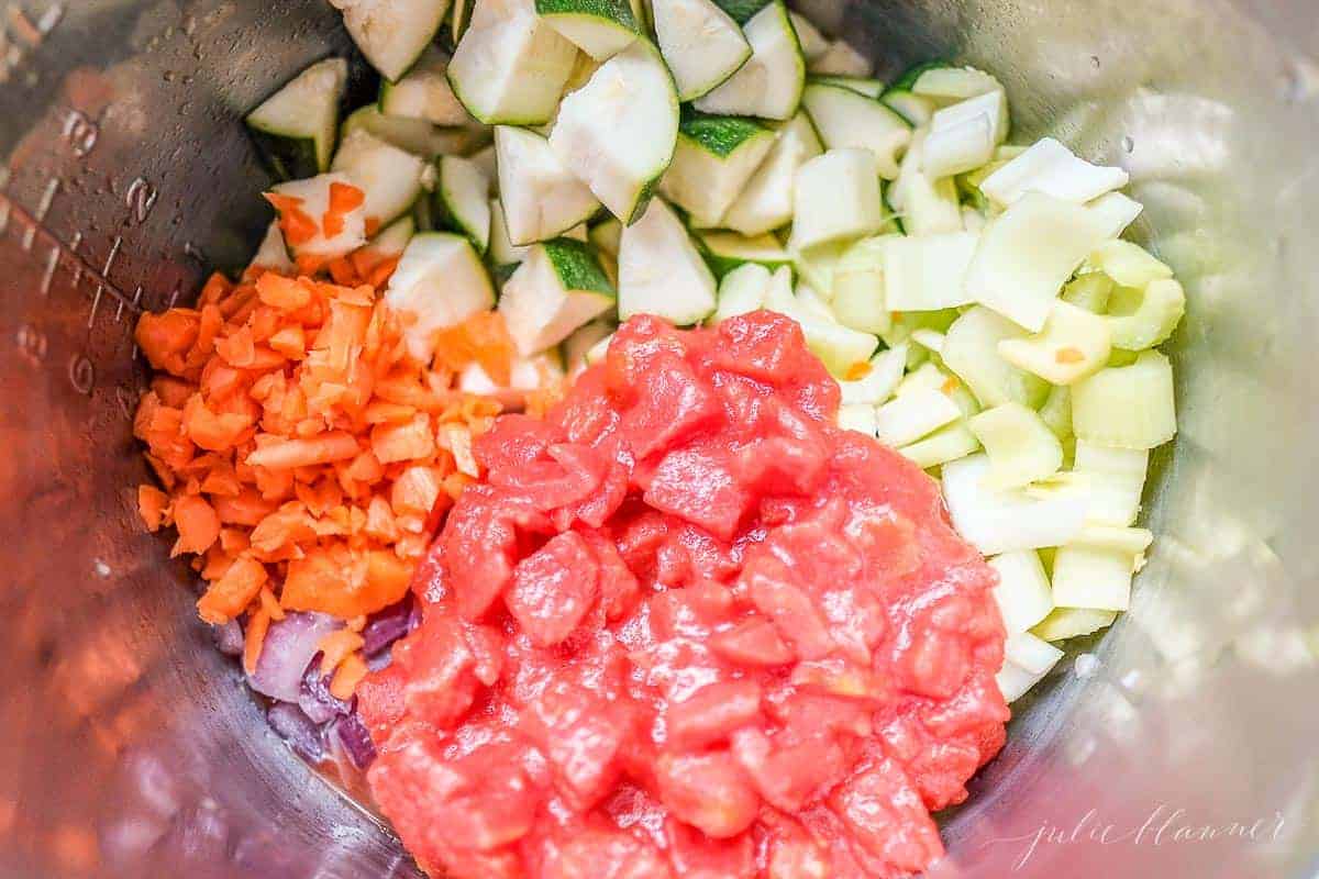 Looking into a pot full of cut vegetables for a minestrone soup recipe.