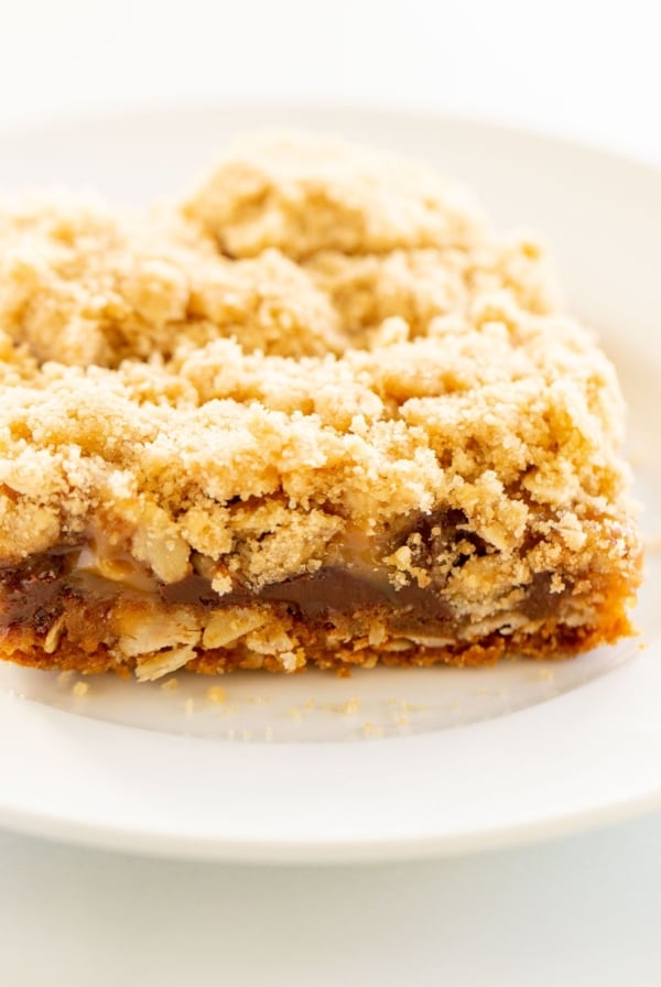 Caramel oatmeal chocolate chip bar on a white plate