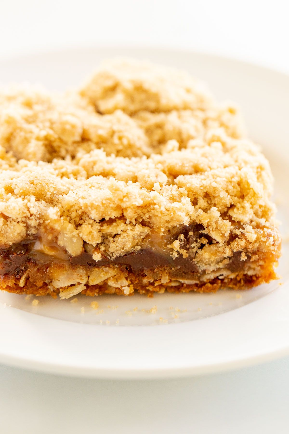 Caramel oatmeal chocolate chip bar on a white plate