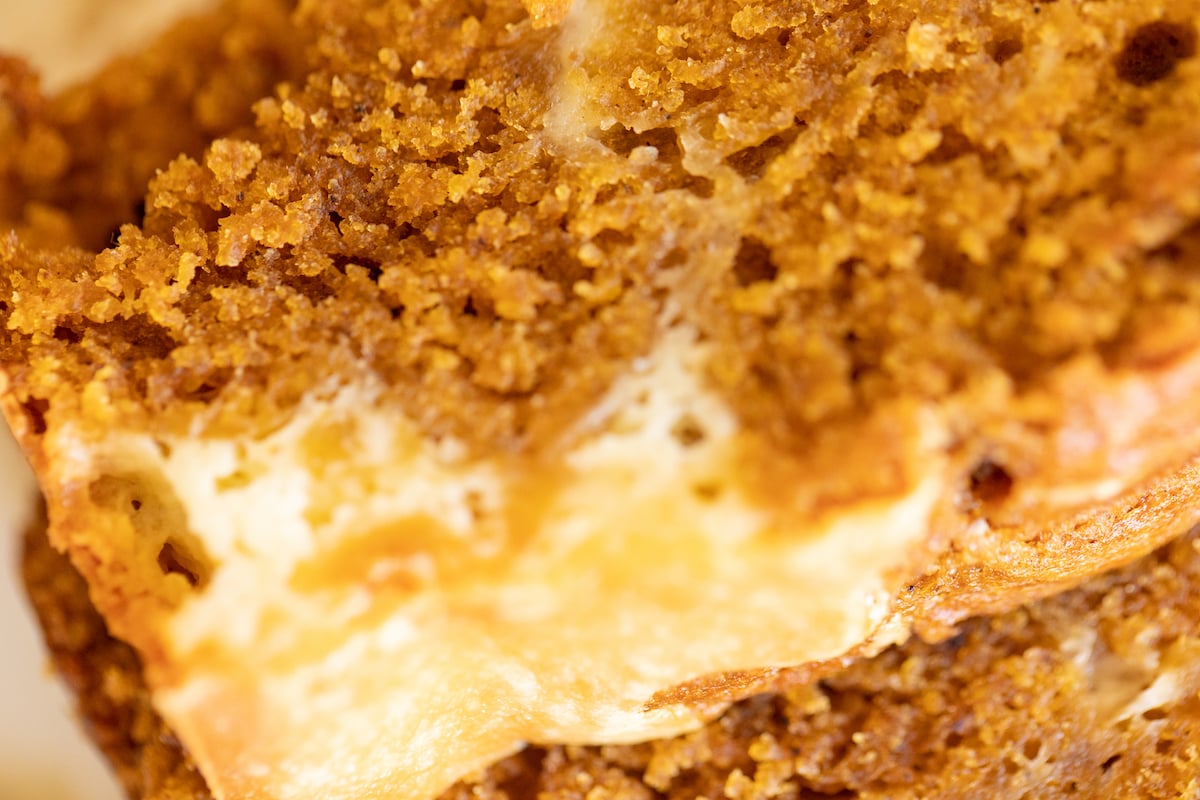 A loaf of pumpkin cheesecake bread on a white platter.
