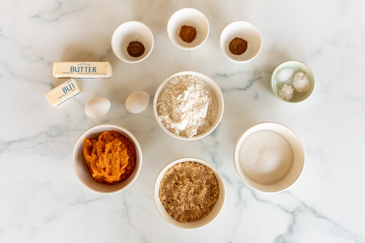 Pumpkin Cheesecake bread ingredients laid out on a marble countertop.