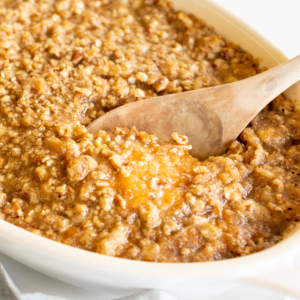 A white oval baking dish full of sweet potato casserole.