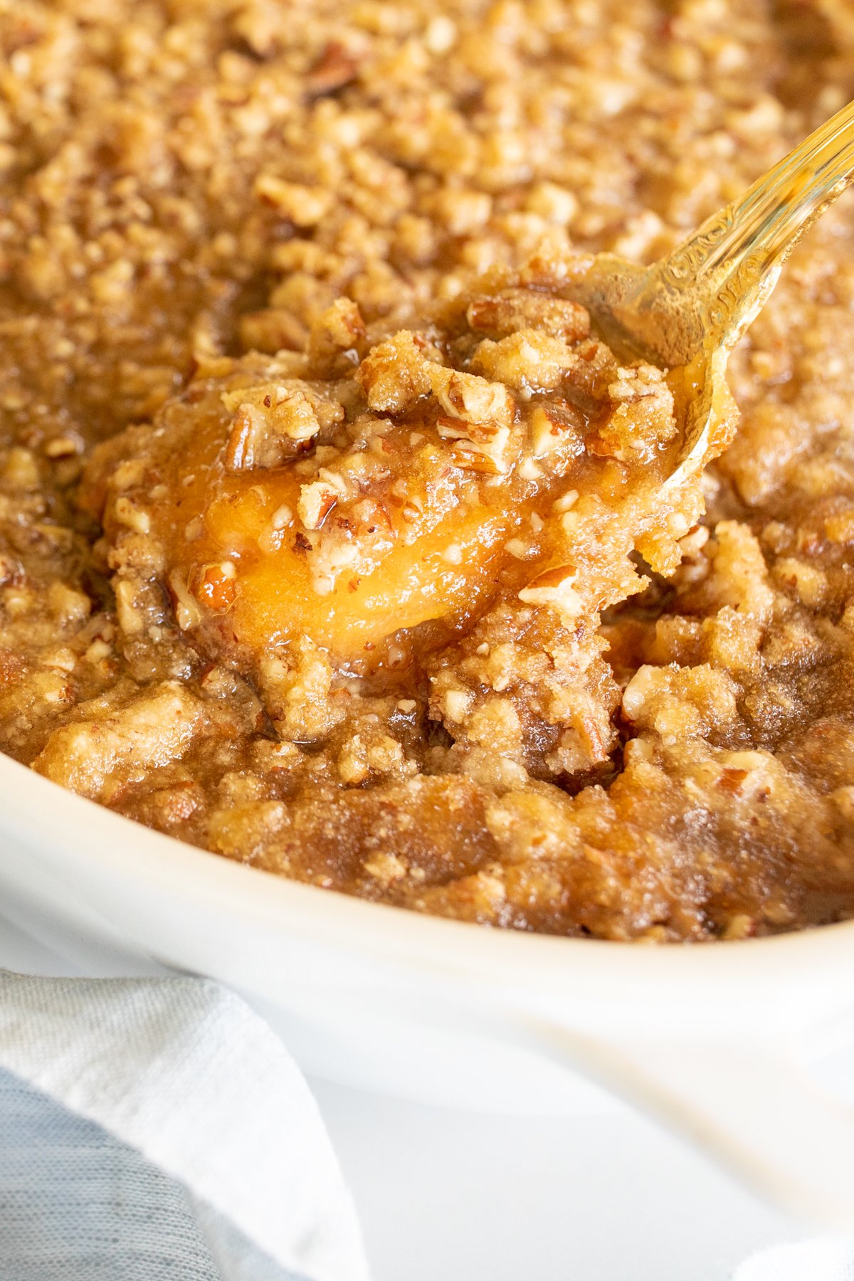 A white oval baking dish full of sweet potato casserole.