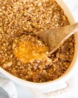 A white oval baking dish full of sweet potato casserole.