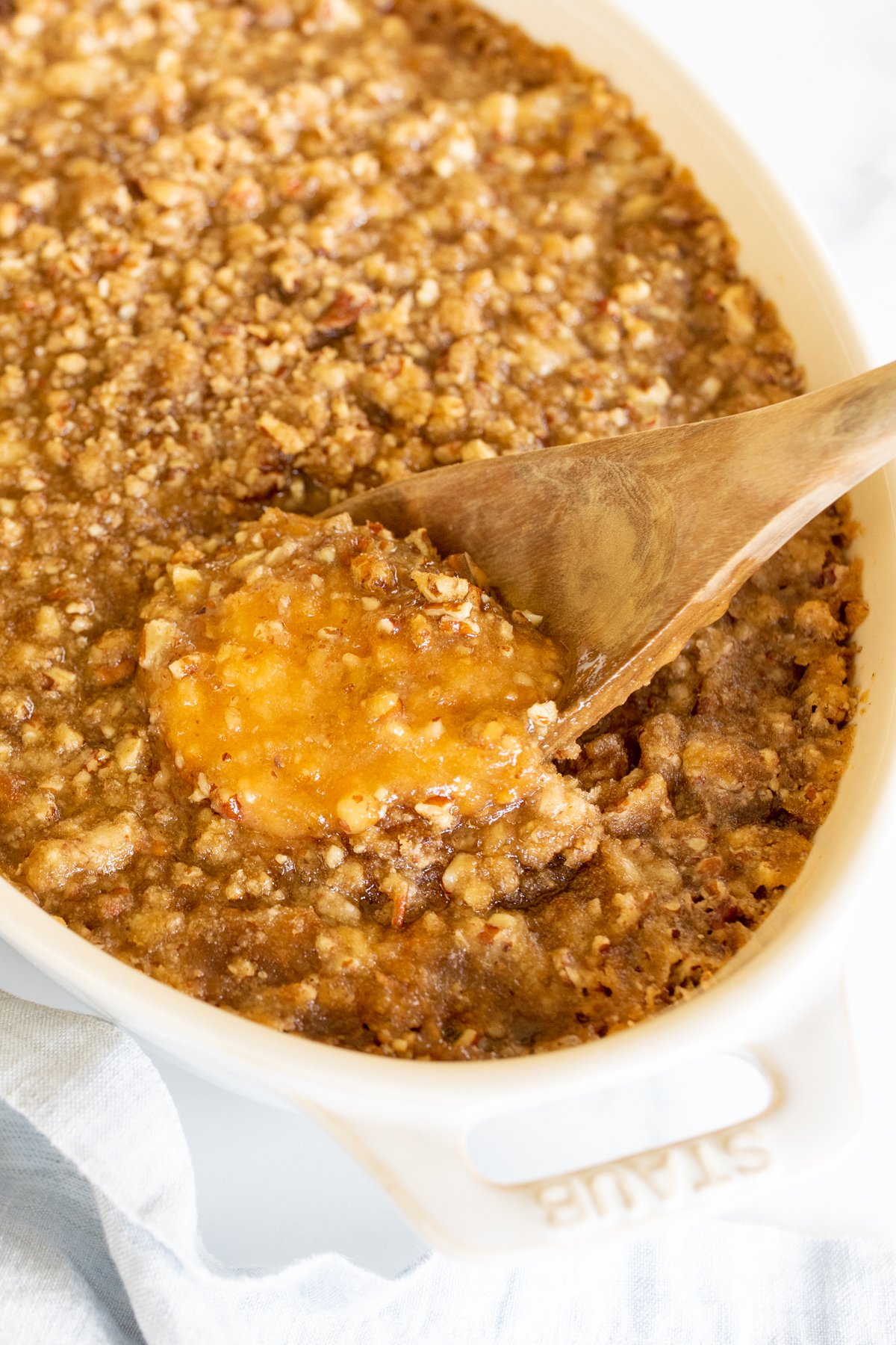 A white oval baking dish full of sweet potato casserole.