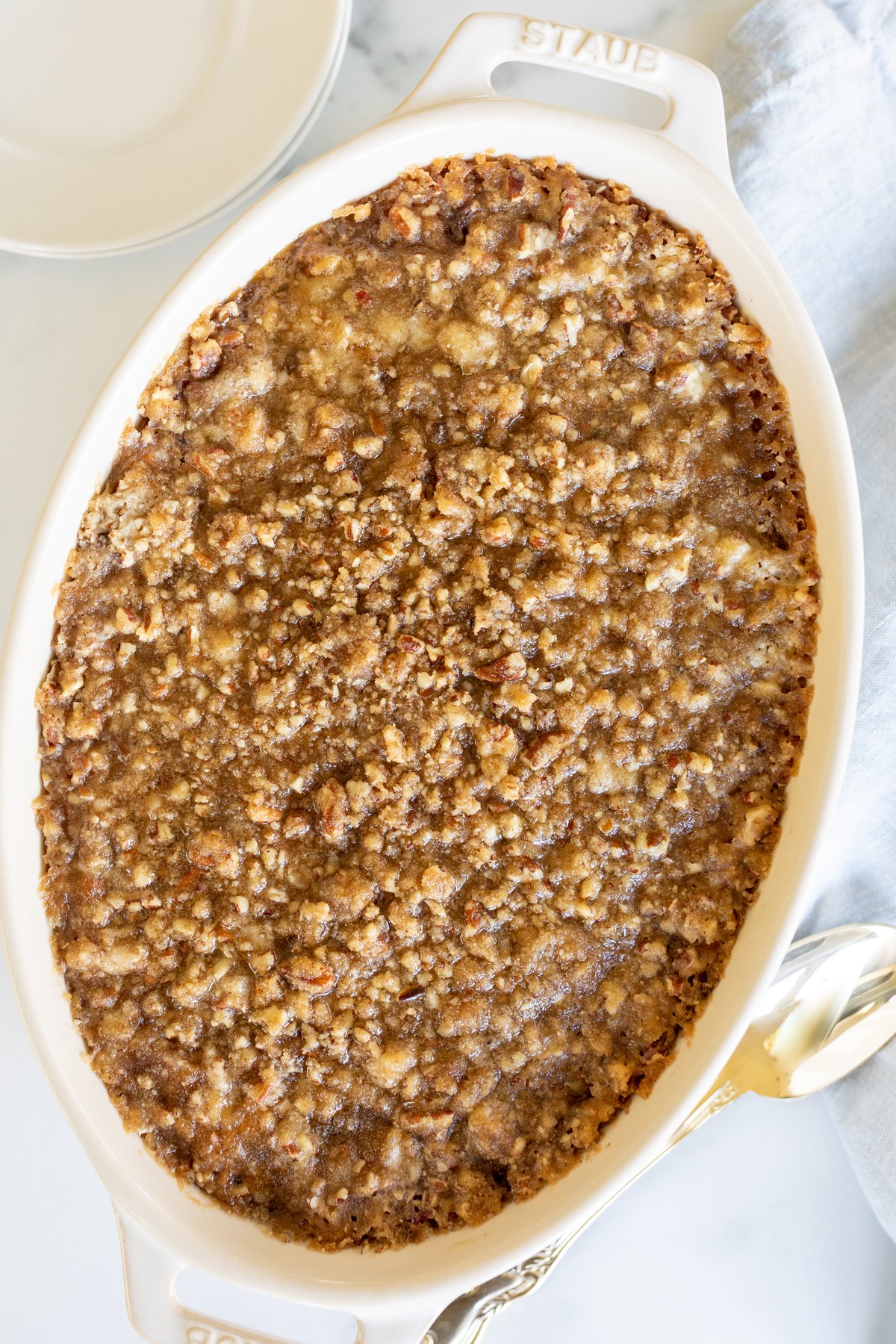 A white oval baking dish full of sweet potato casserole.