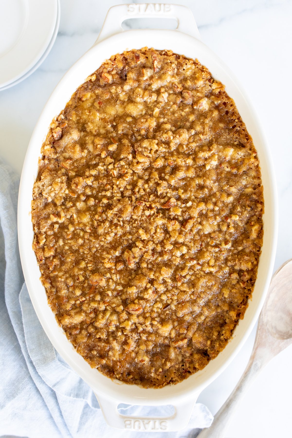 A white oval baking dish full of sweet potato casserole.