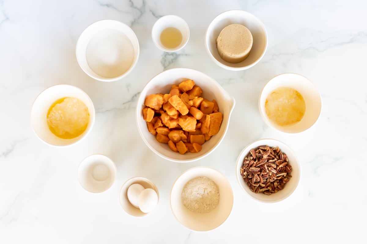 Ingredients for a sweet potato casserole recipe laid out on a white countertop.