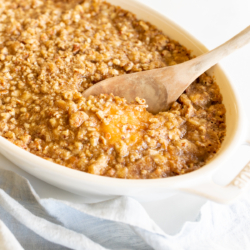 A white oval baking dish full of sweet potato casserole.