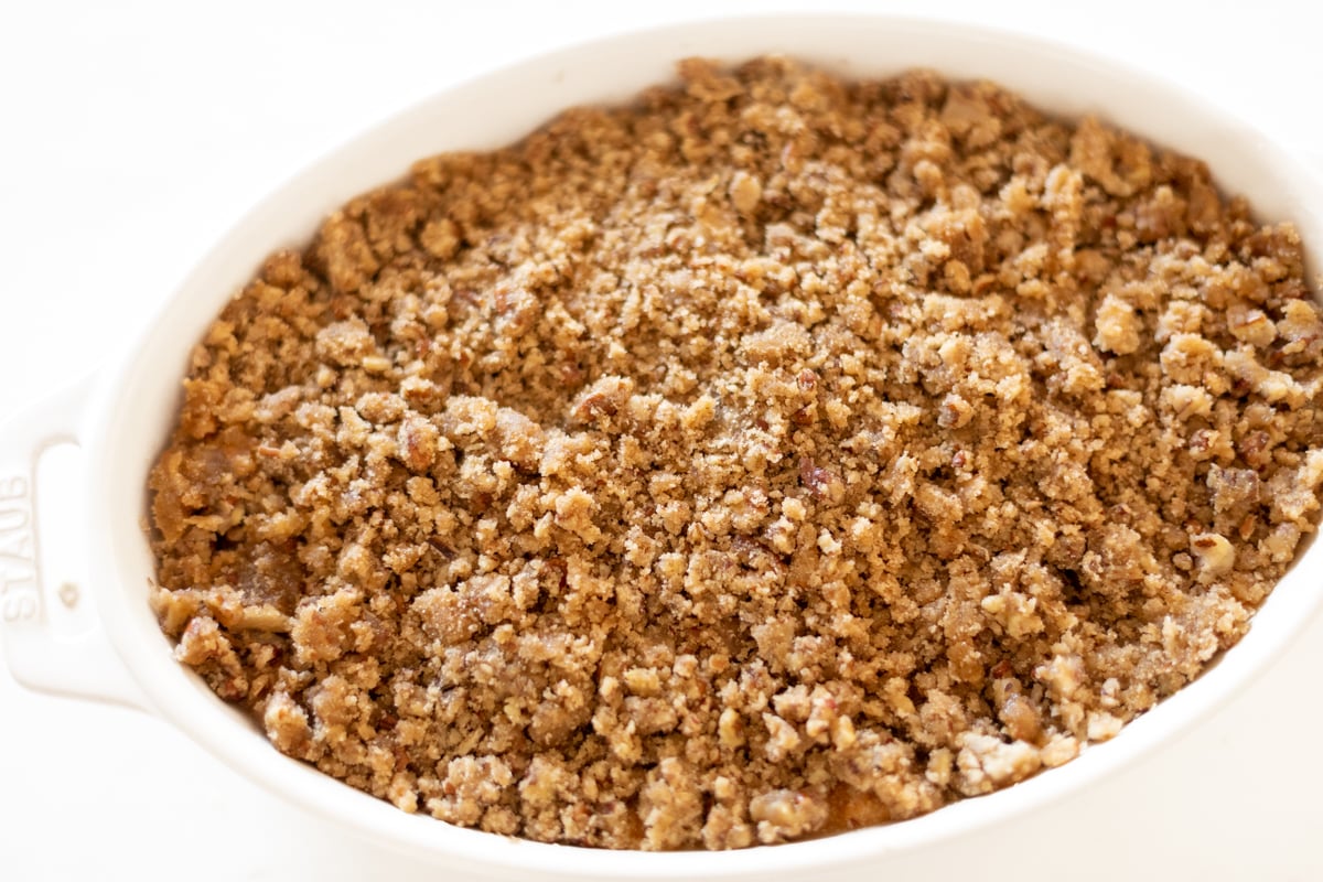 A white oval baking dish full of sweet potato casserole.