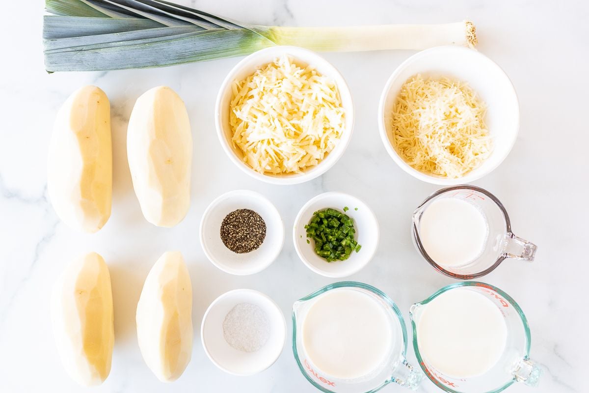 Ingredients for gratin dauphinoise potatoes laid out on a marble countertop.