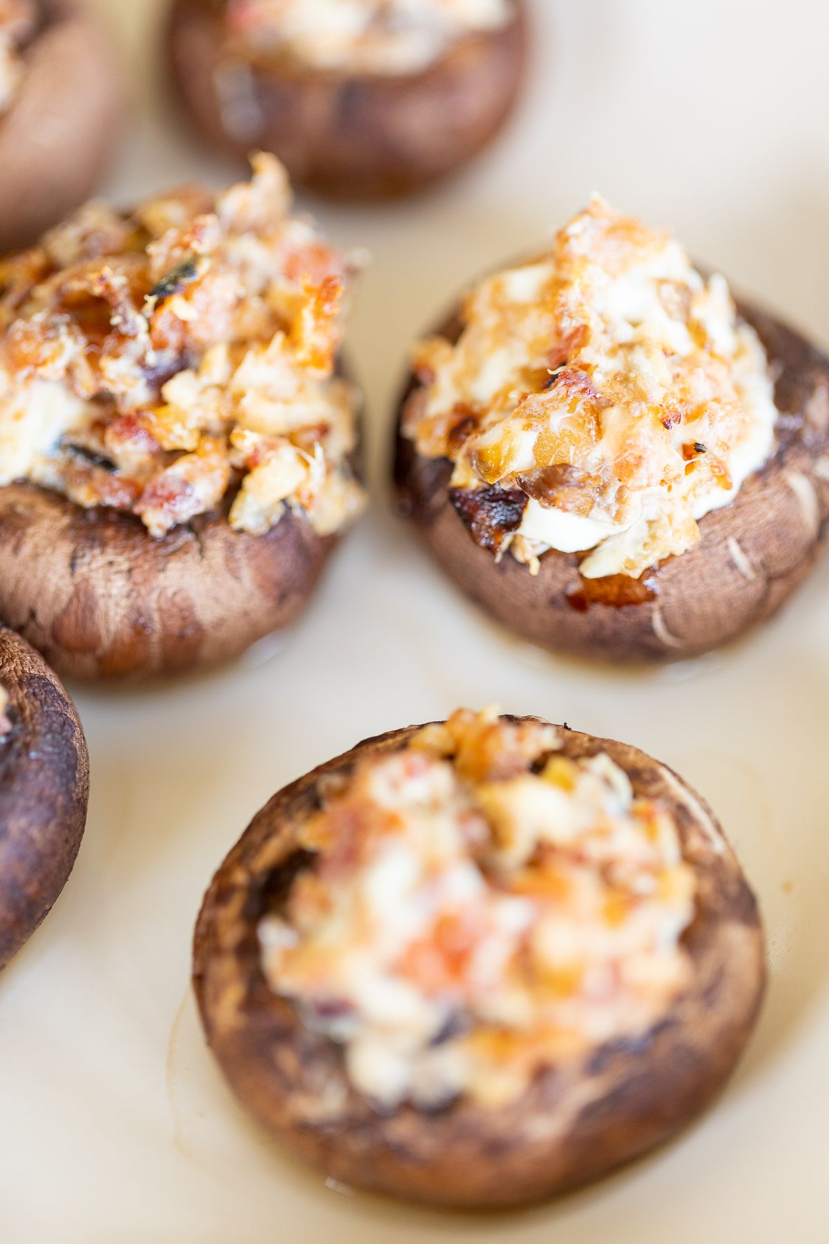 Bacon stuffed mushrooms on a white platter.