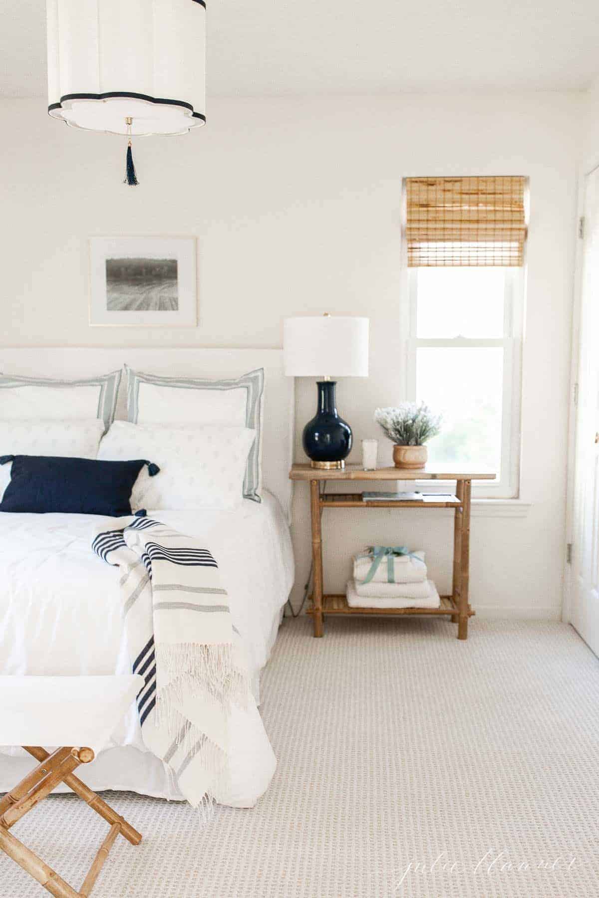 A white guest room with blue accents.