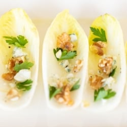 An endive salad laid out on a white platter.