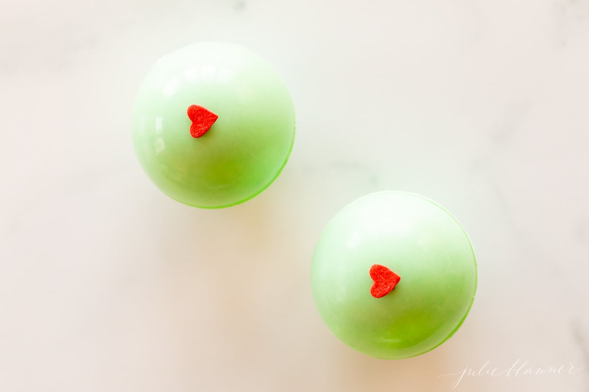 Two grinch hot chocolate bombs