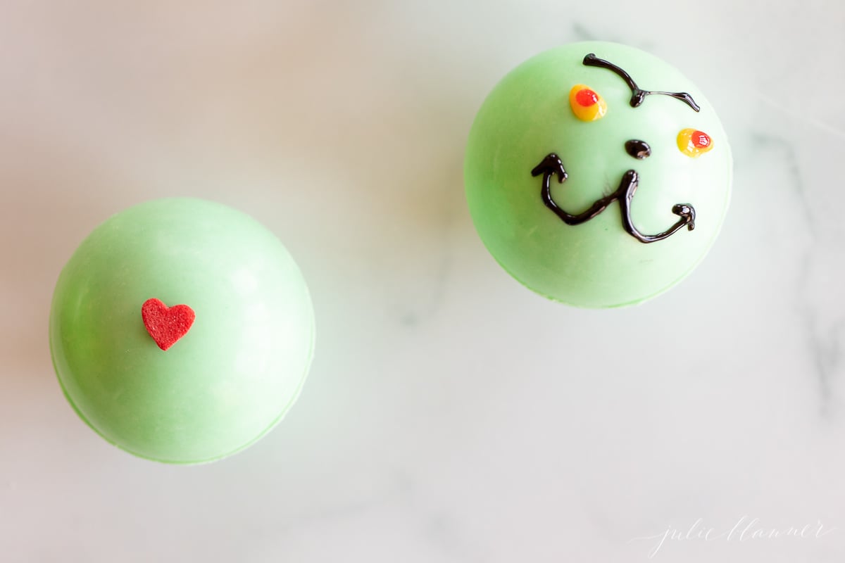 Two grinch hot chocolate bombs