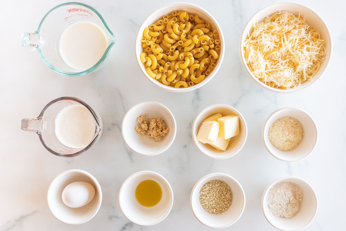 Ingredients for mac and cheese laid out on a marble countertop.