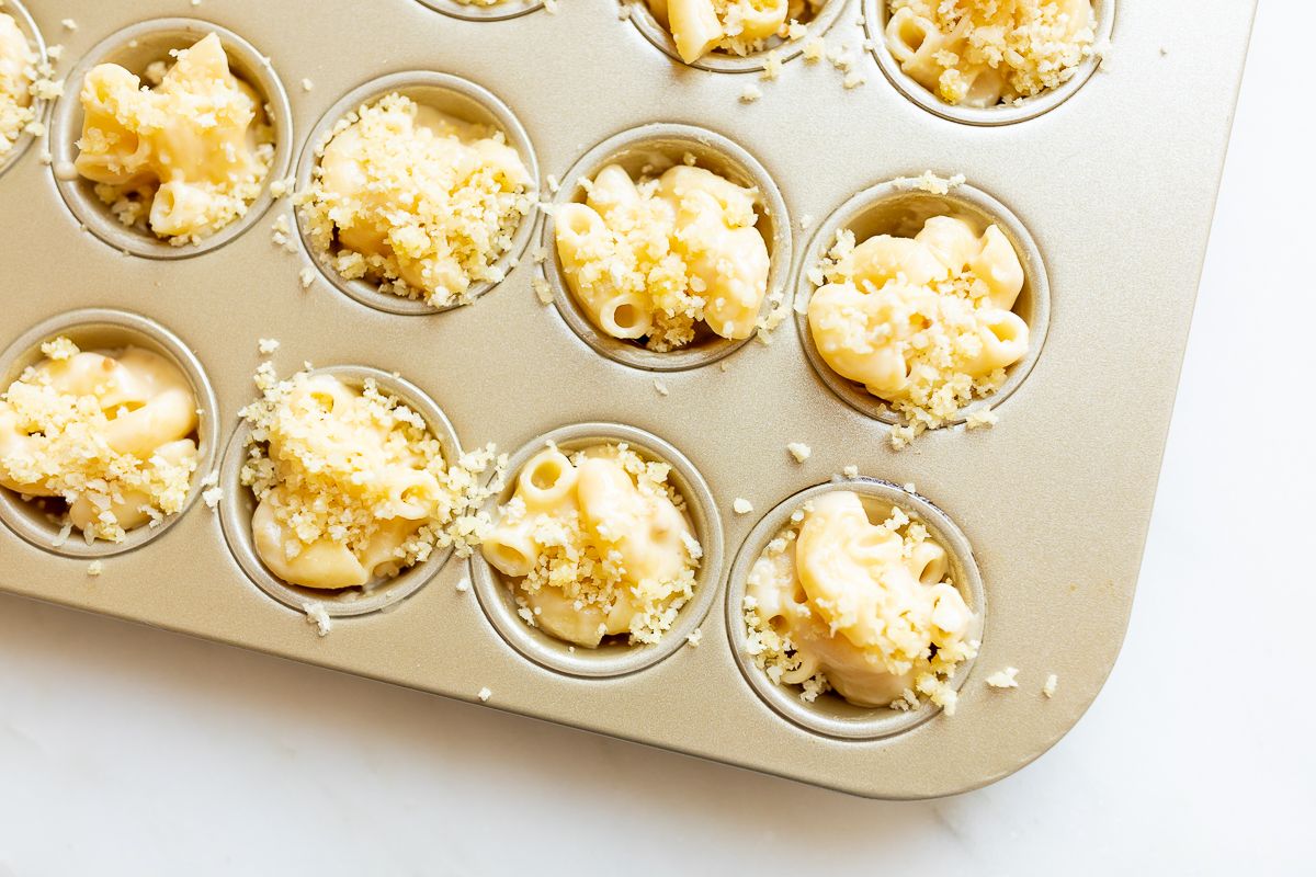 A mini muffin tin filled with mac and cheese cups.