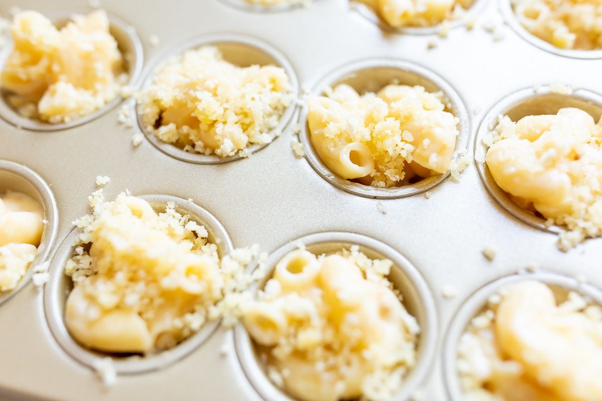 A mini muffin tin filled with mac and cheese cups.