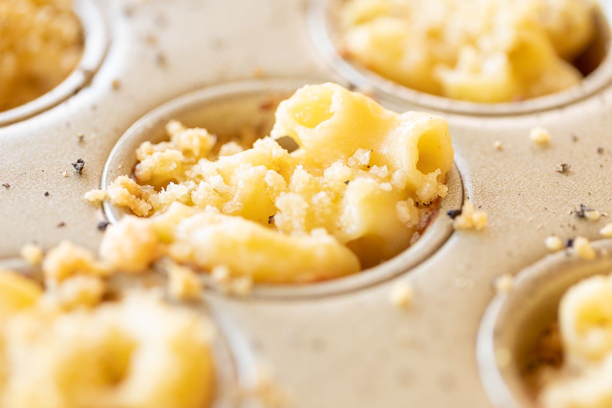 A mini muffin tin filled with mac and cheese cups.