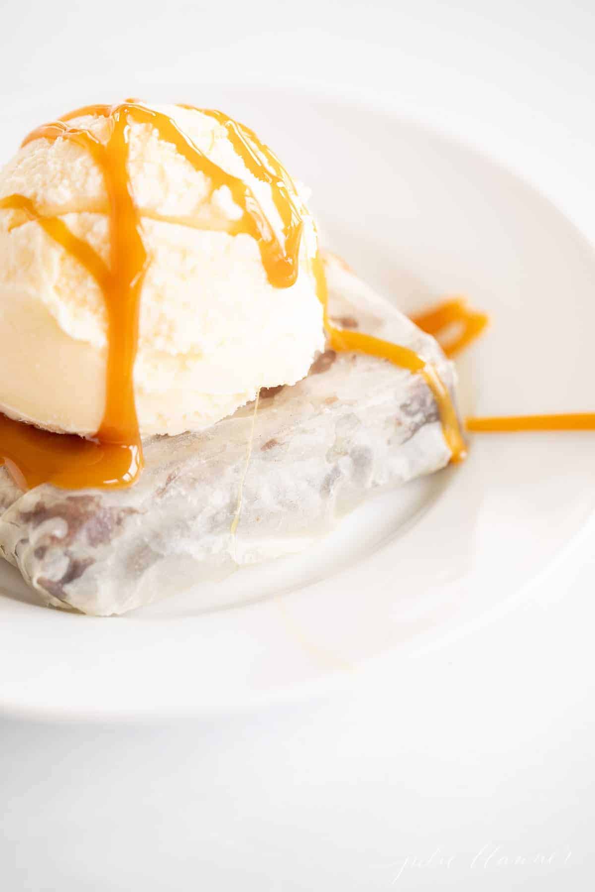 phyllo brownie on white plate topped with ice cream