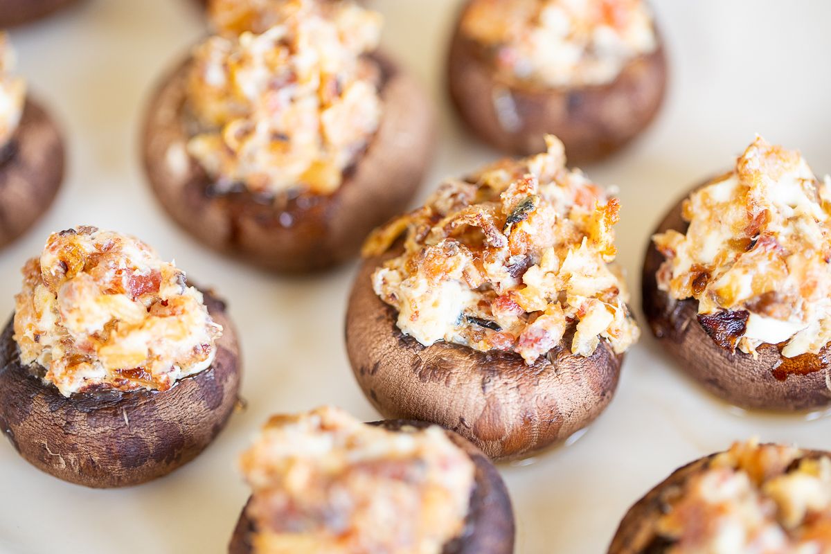 Bacon stuffed mushrooms on a white platter.