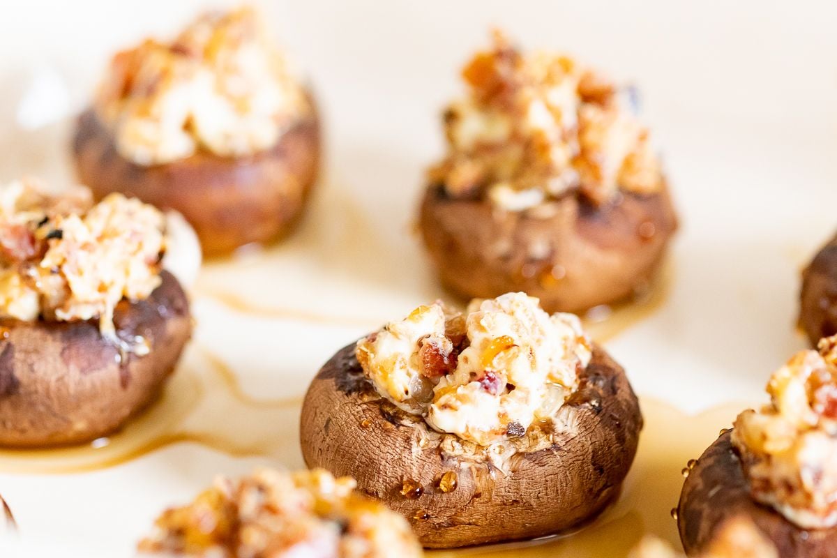 Bacon stuffed mushrooms on a white platter.