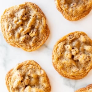 Pecan pie cookies laid out on a white surface.