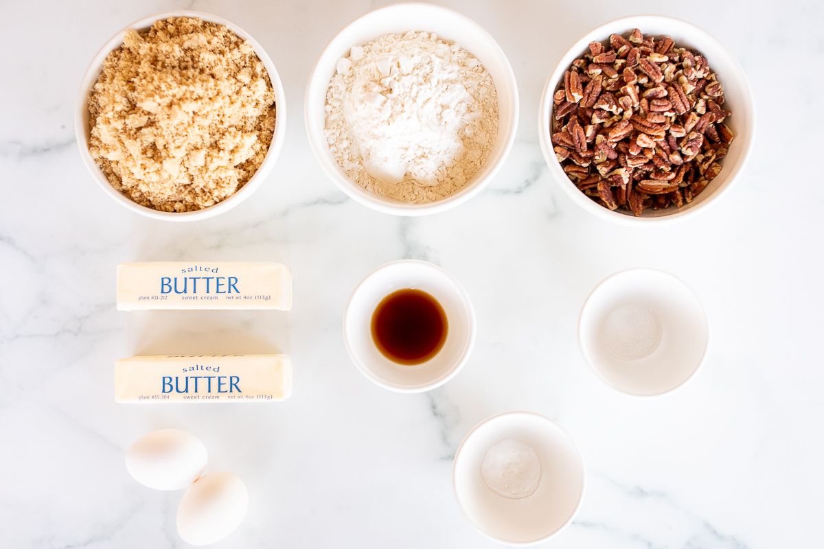 Ingredients for pecan pie cookies, laid out on a marble surface.