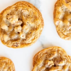 Pecan pie cookies laid out on a white surface.