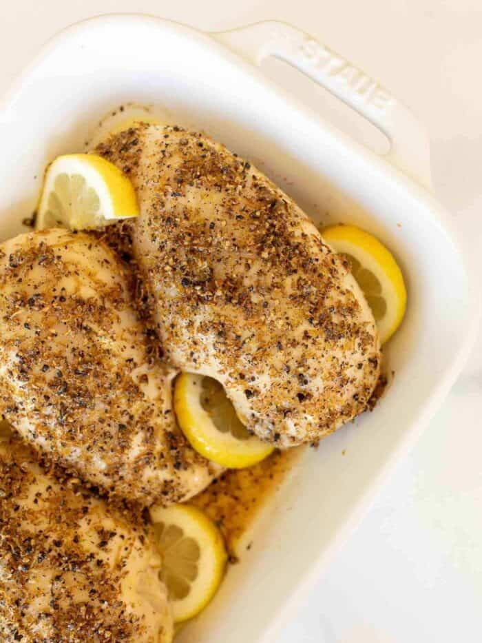 lemon pepper chicken in white casserole dish