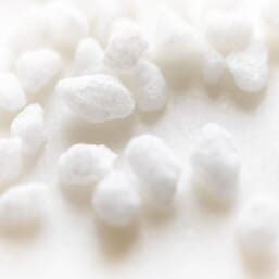 pearl sugar nibs scattered on a white surface.