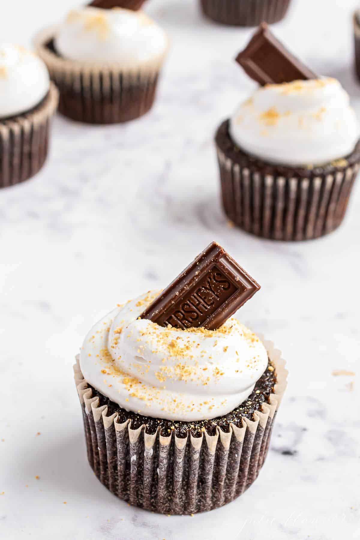 S'mores cupcakes on a marble surface.