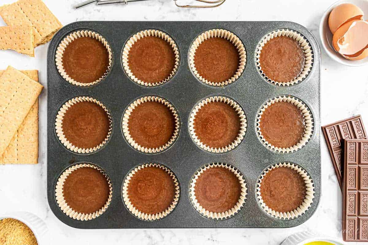 chocolate cupcake batter poured into liners in a cupcake pan.