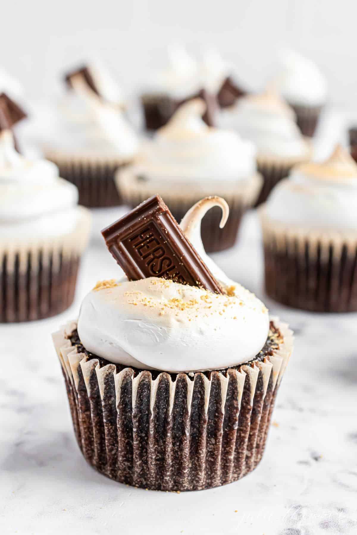 S'mores cupcakes on a marble surface.