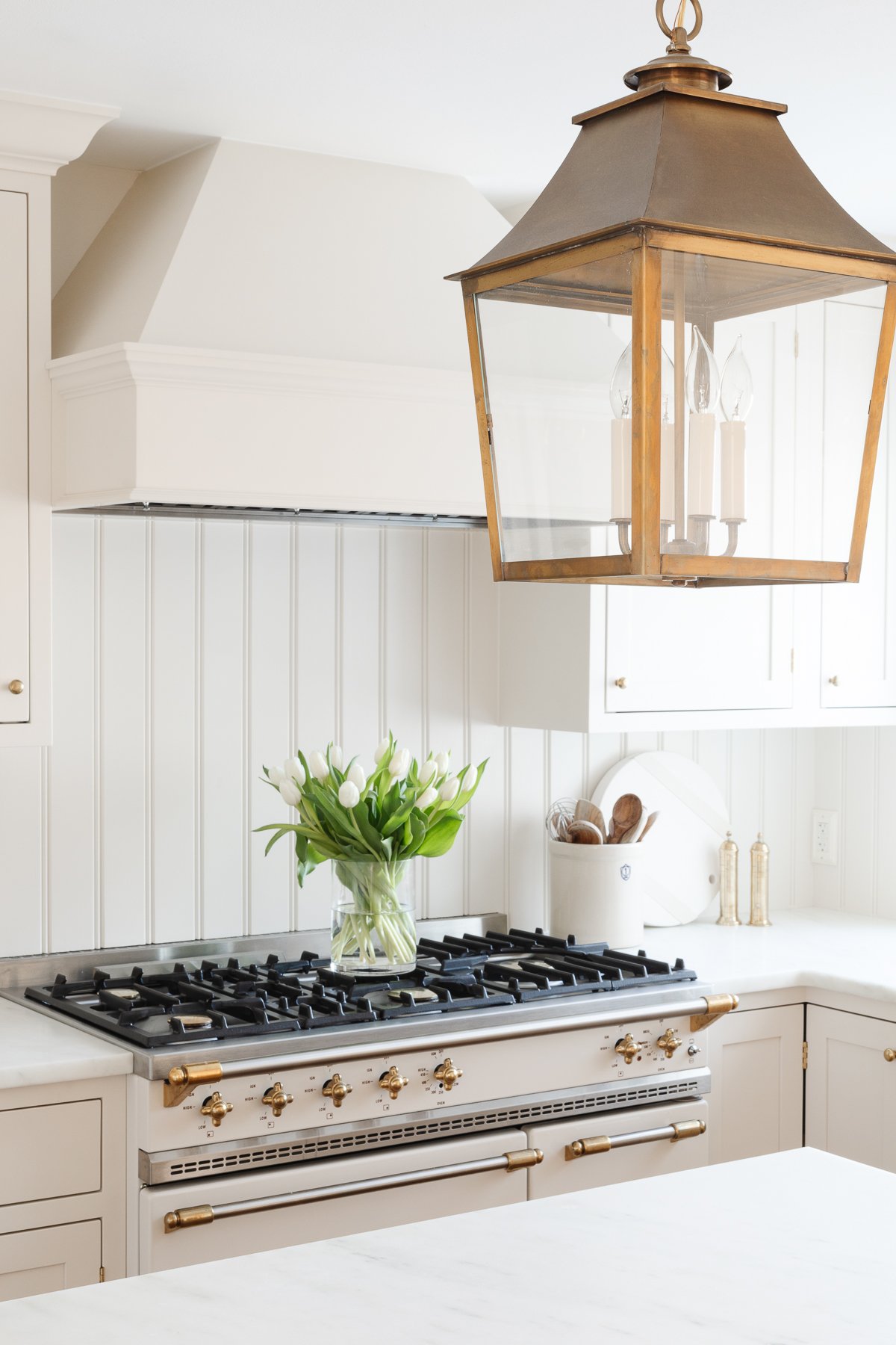 A white kitchen with a beadboard backsplash