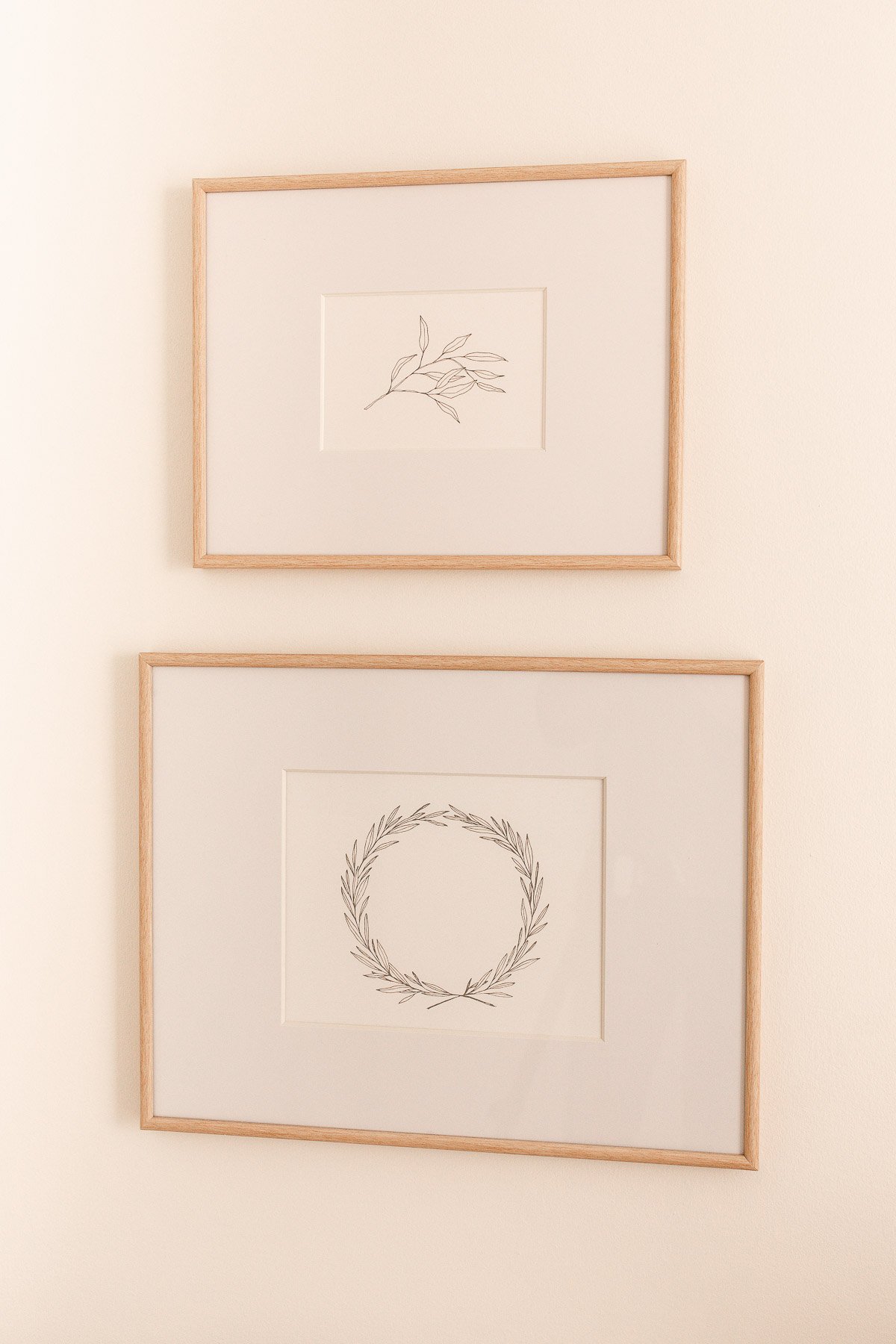 Two framed drawings of public domain art hanging on a wall.