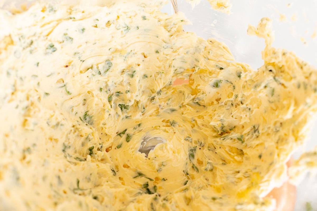 Steak butter with fresh herbs inside the bowl of a stand mixer