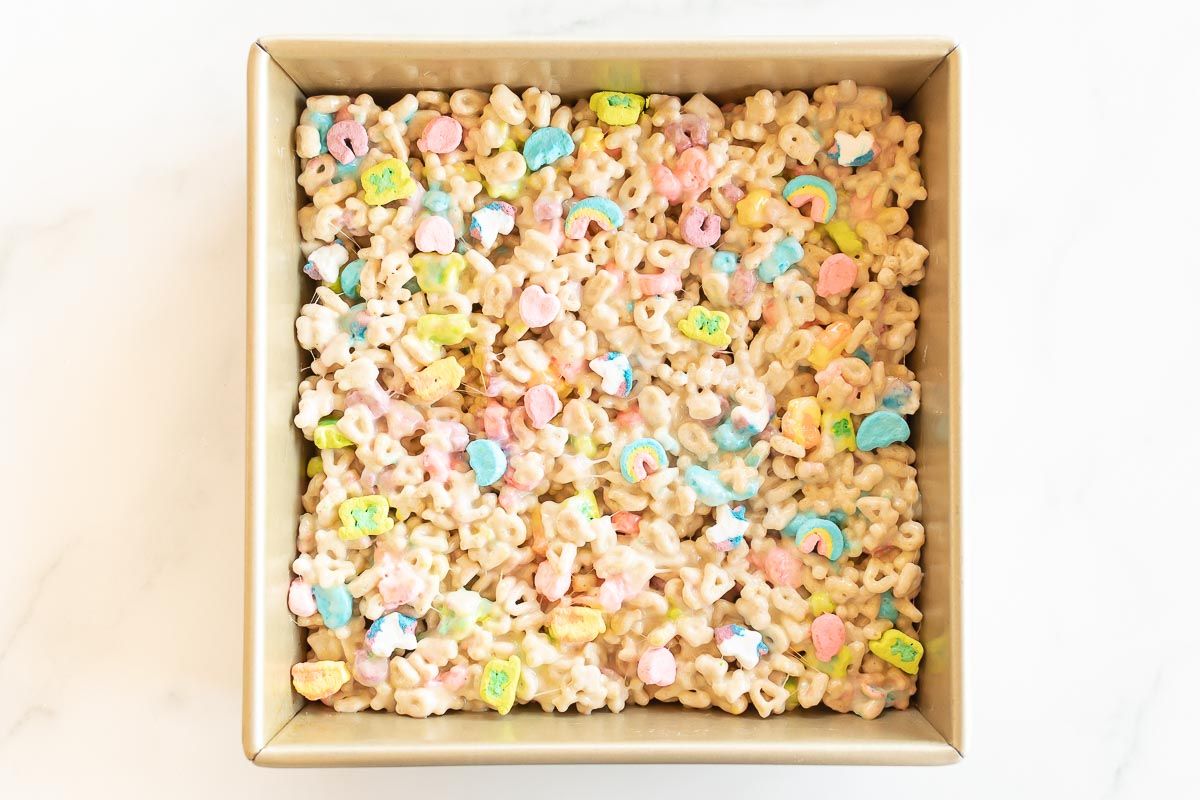 a gold baking pan filled with no bake lucky charms bars.