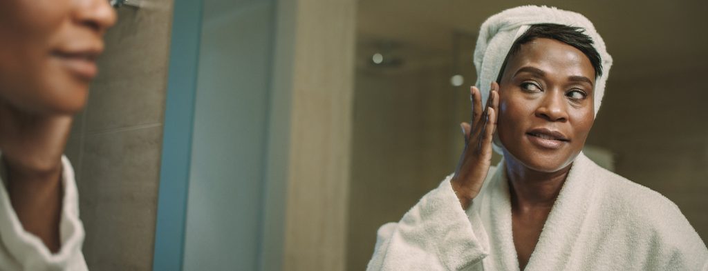 Woman applying serum for dry skin