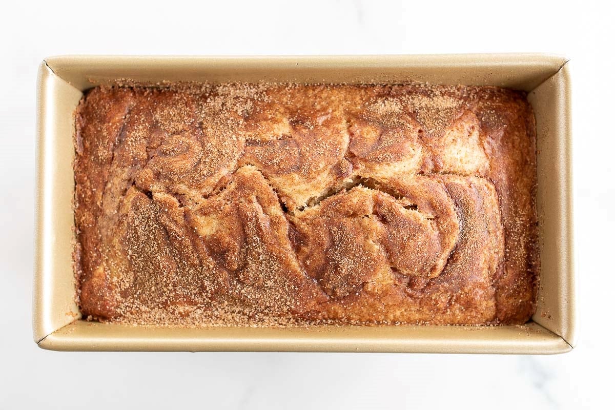 banana bread with no baking powder or baking soda in a gold loaf pan.