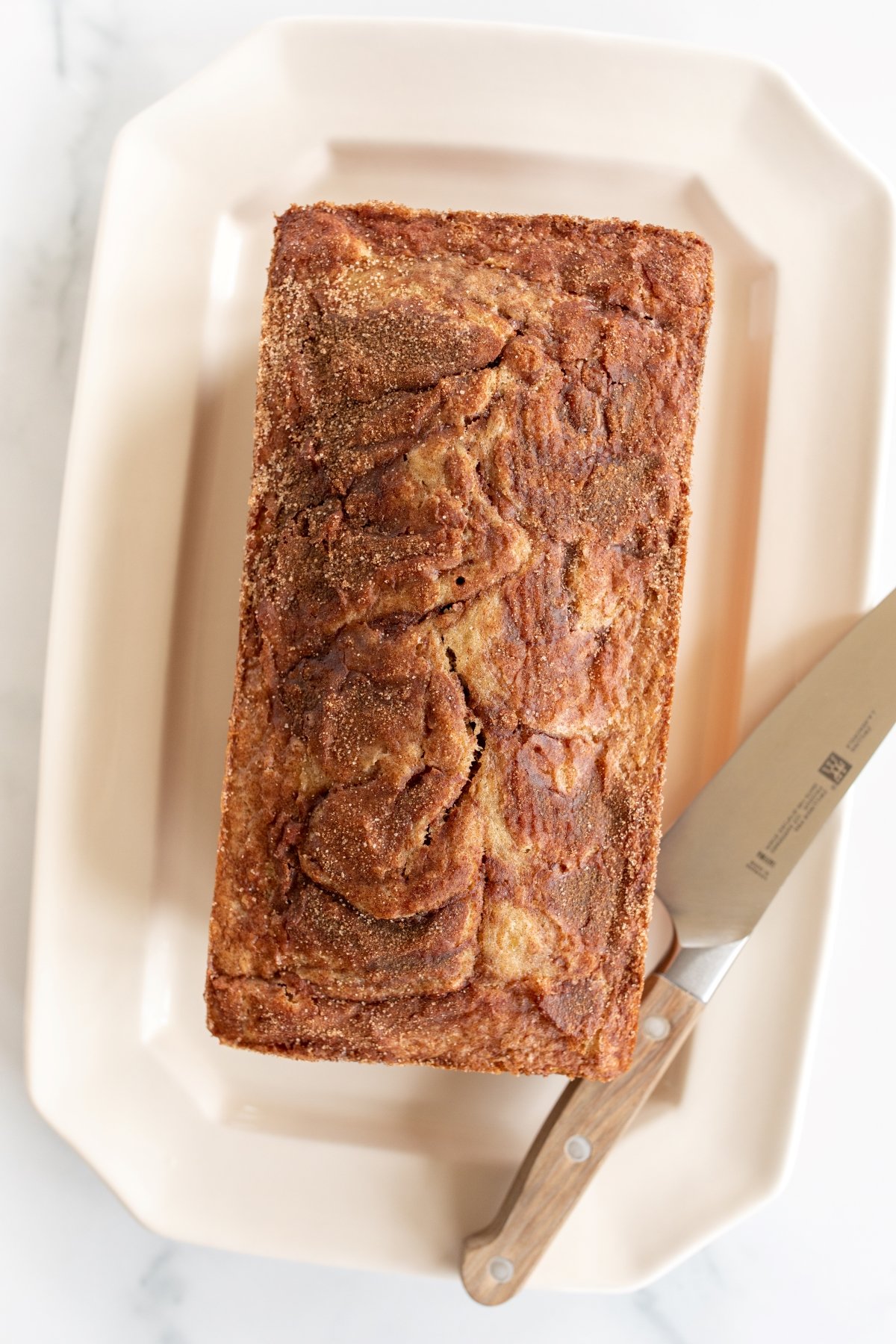 a loaf of banana bread on a white platter