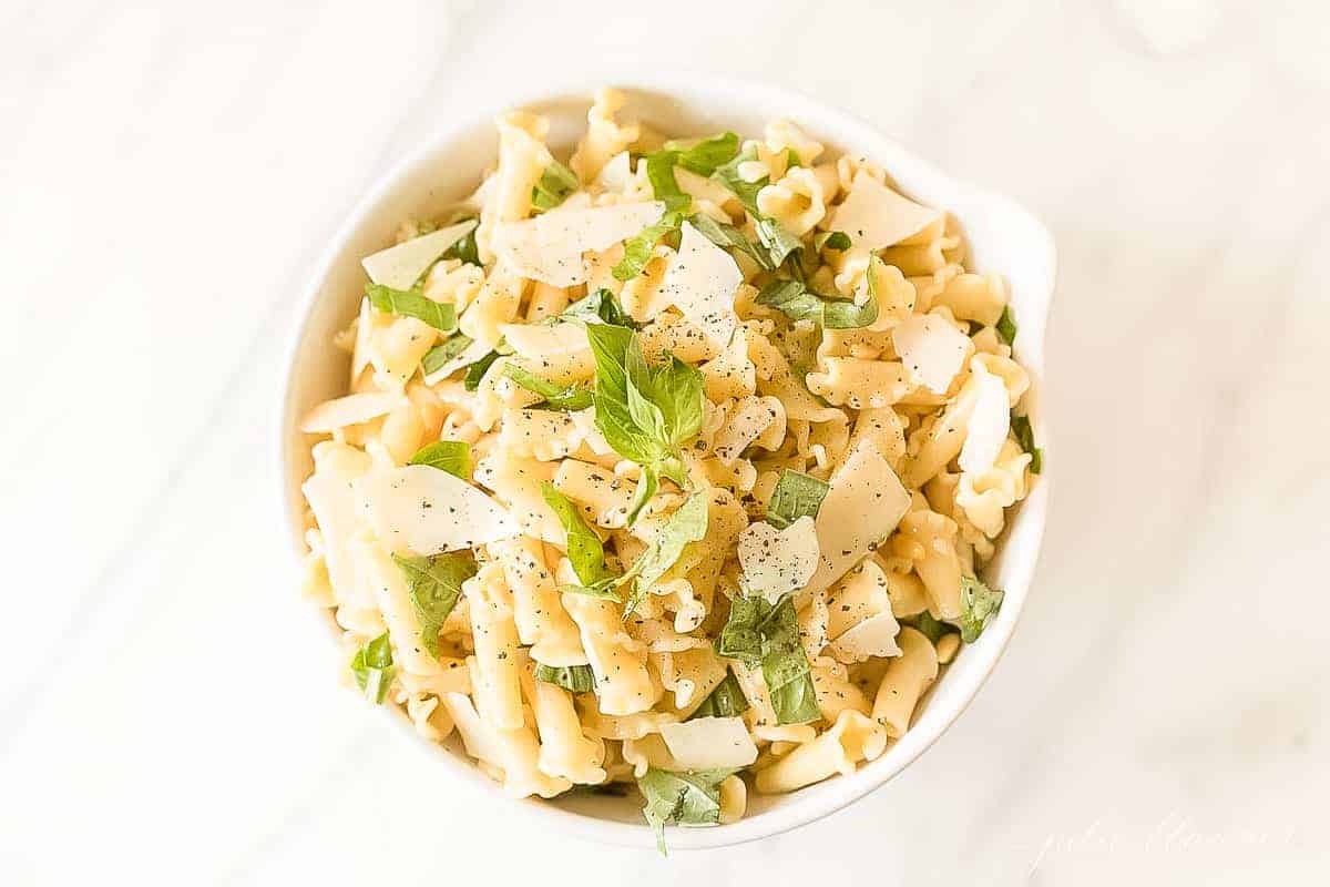 pasta salad topped with basil and parmesan