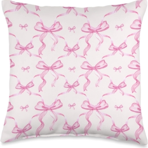 A pink pillow with bows on it, perfect for a tween girl bedroom.