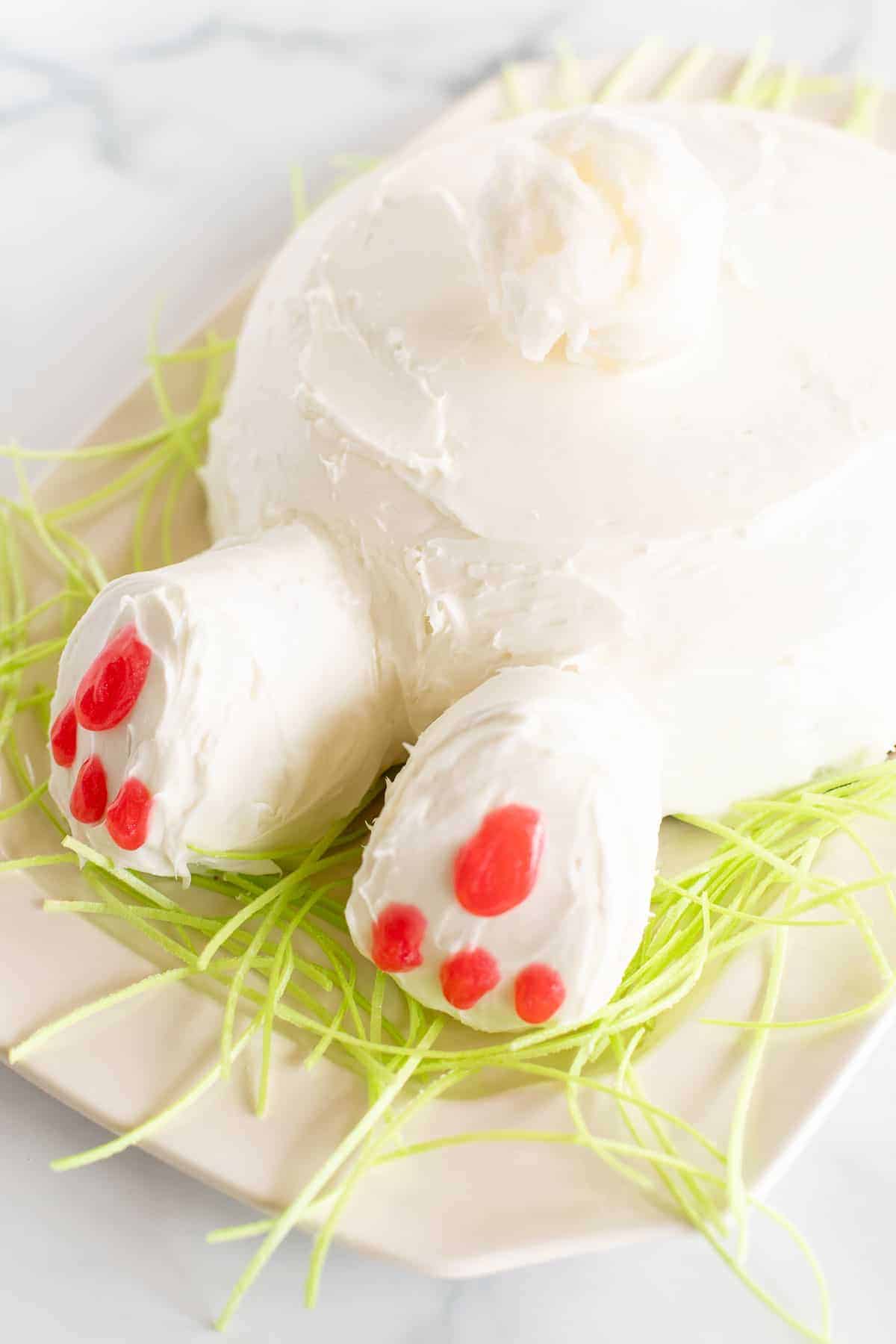 bunny butt cake on platter with green grass