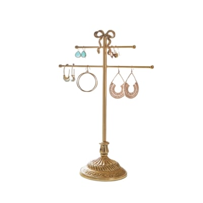 A gold earring stand with earrings on it is a perfect addition to a tween bedroom.