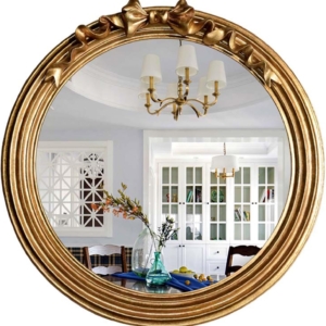 A gold framed mirror in a tween girl bedroom.