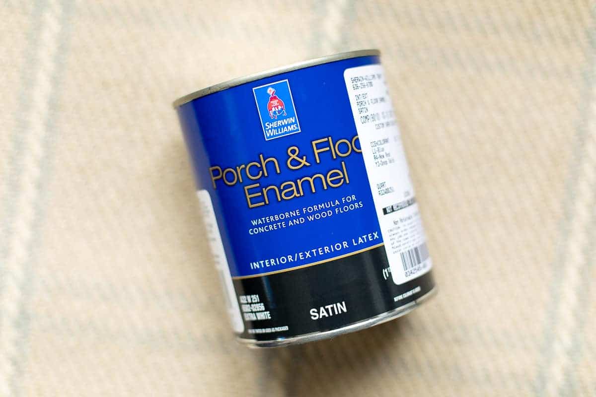 can of paint for vinyl or linoleum floors displayed on a plaid rug