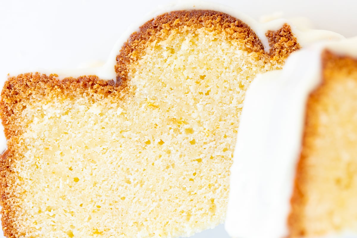 An orange pound cake on a white serving platter.