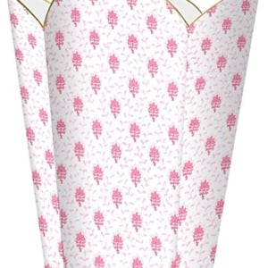 A pink flower shaped trash can with a gold handle, perfect for tween bedroom ideas.